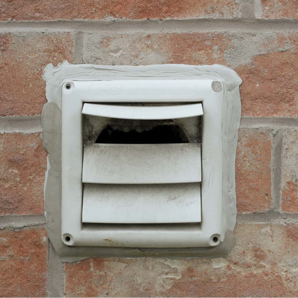Vent on the outside of a brick house