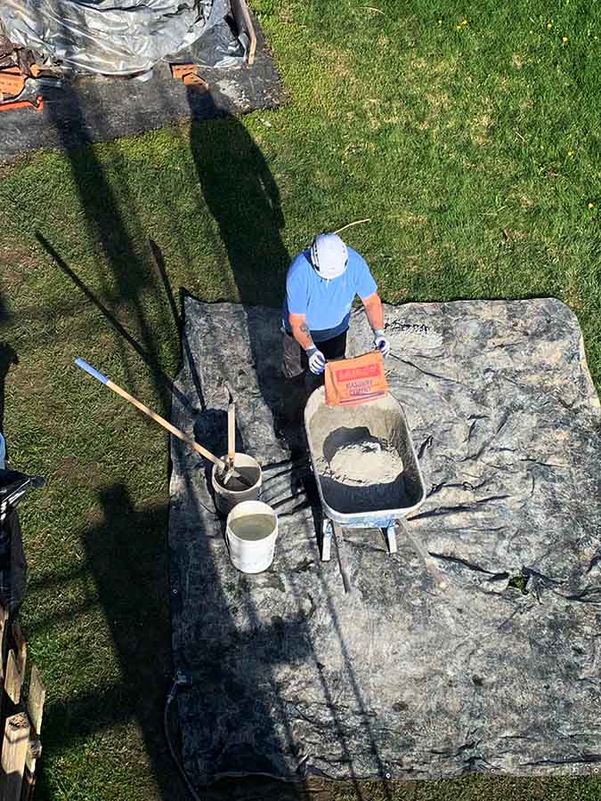 An overhead view of an employee making mortar