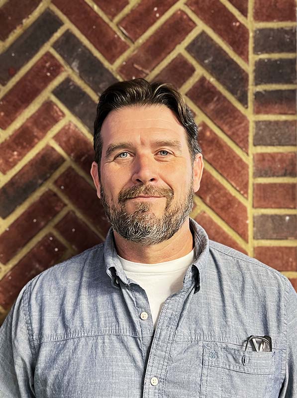 Bill Bishop - Lead Service Technician - Brown hair combed back with blue eyes, a mustache and a short grayish beard.