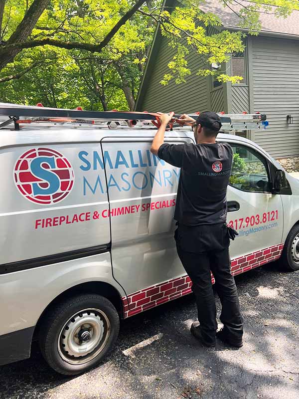 Employee standing in front of Smalling Masonry van