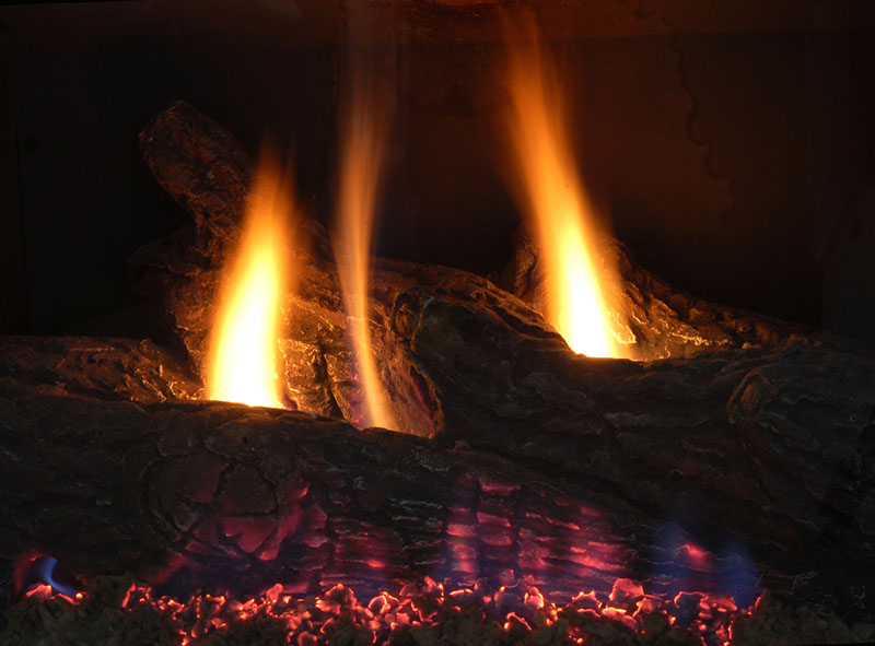 gas longs inside a fire place lit up