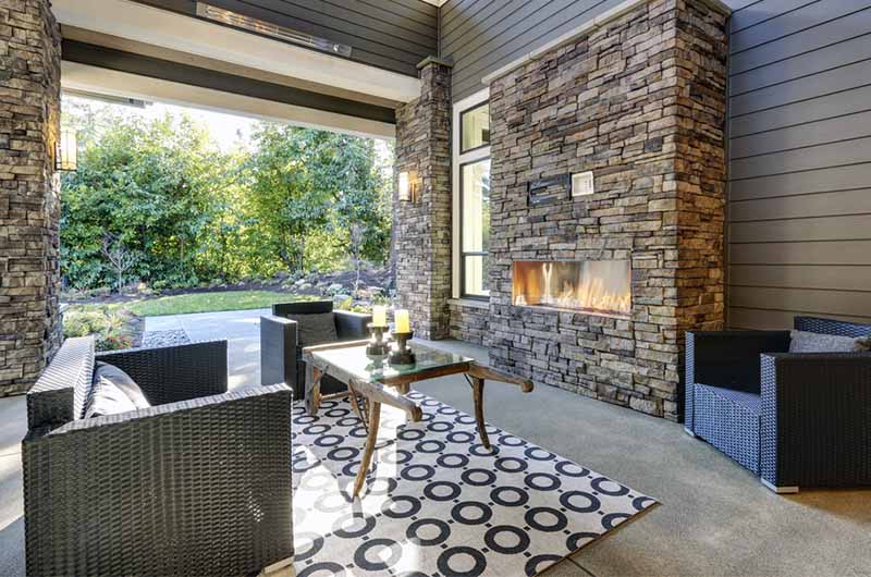 Outdoor patio seating surrounding an outdoor fireplace 