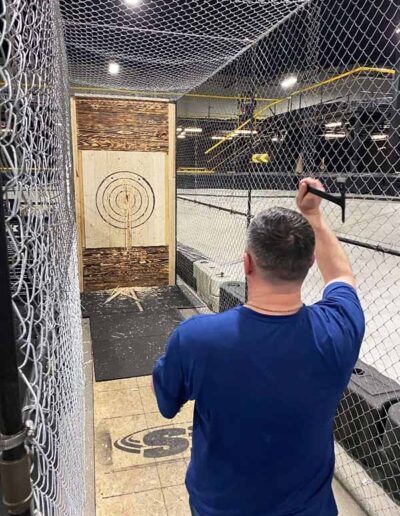 Employee throwing axes at team building trip