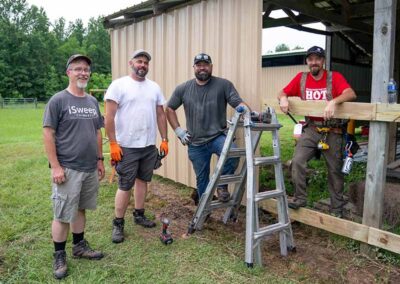 Warrior Horse volunteers building a barn