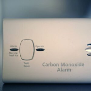 a close view of a white, rectangle carbon monoxide alarm