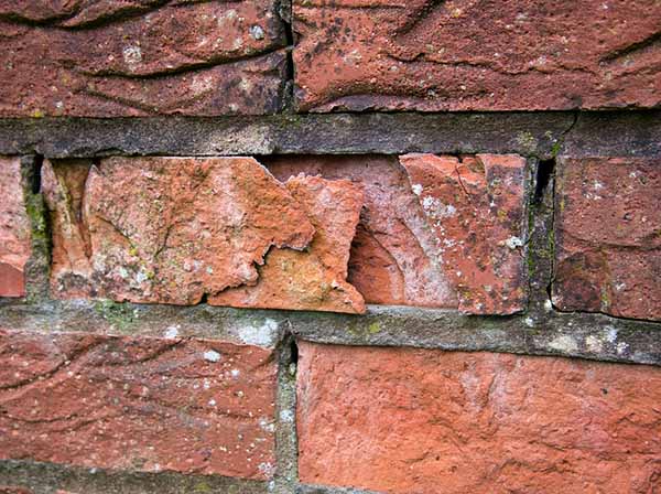 Brickwork flaking off due to water damage