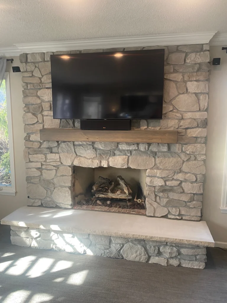 The Smalling Masonry work truck wrapped with a brick design and the Smalling Masonry logo. There is a tudor house in the background.
