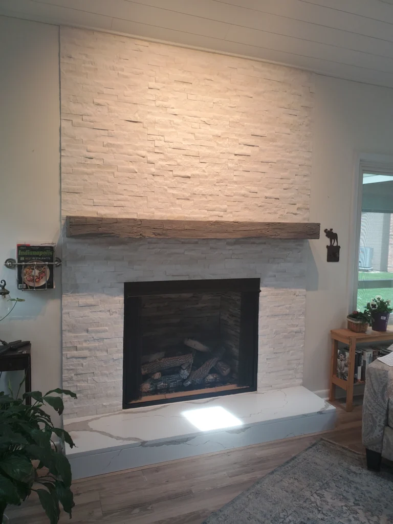 The Smalling Masonry work truck wrapped with a brick design and the Smalling Masonry logo. There is a tudor house in the background.