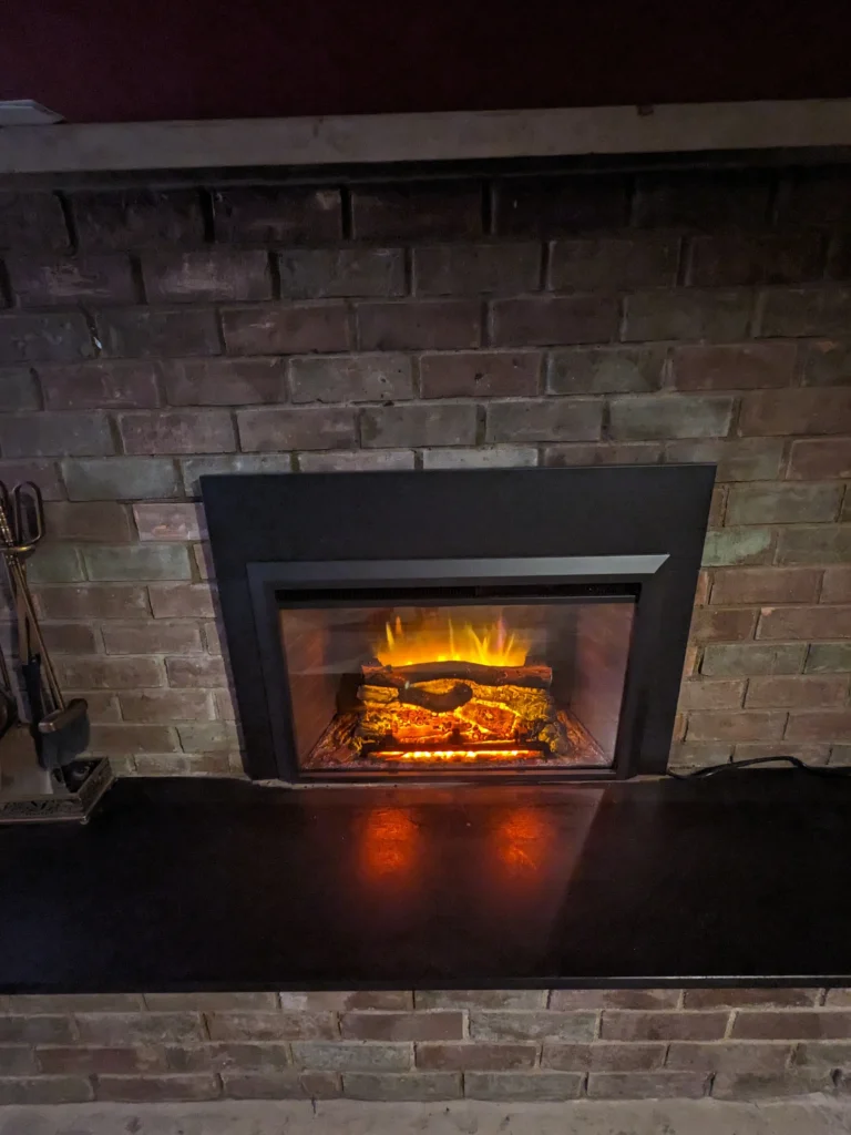 The Smalling Masonry work truck wrapped with a brick design and the Smalling Masonry logo. There is a tudor house in the background.