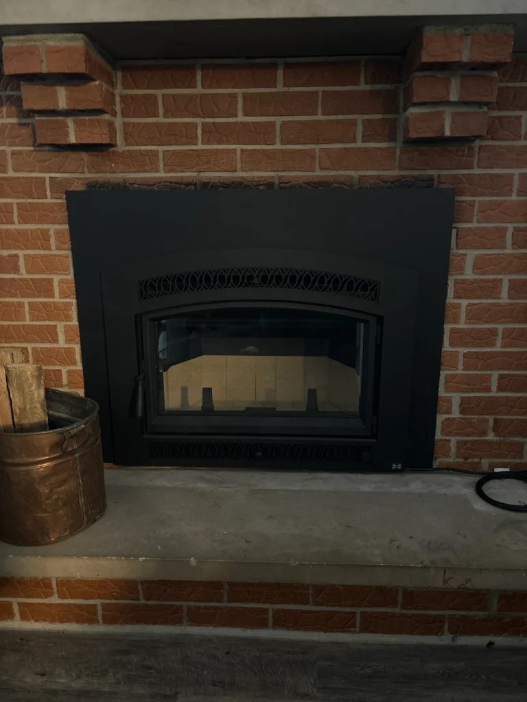 The Smalling Masonry work truck wrapped with a brick design and the Smalling Masonry logo. There is a tudor house in the background.